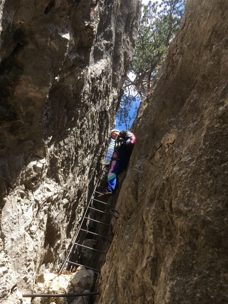 Herbert at the crux (slightly overhanging ladder leading out the chimney)