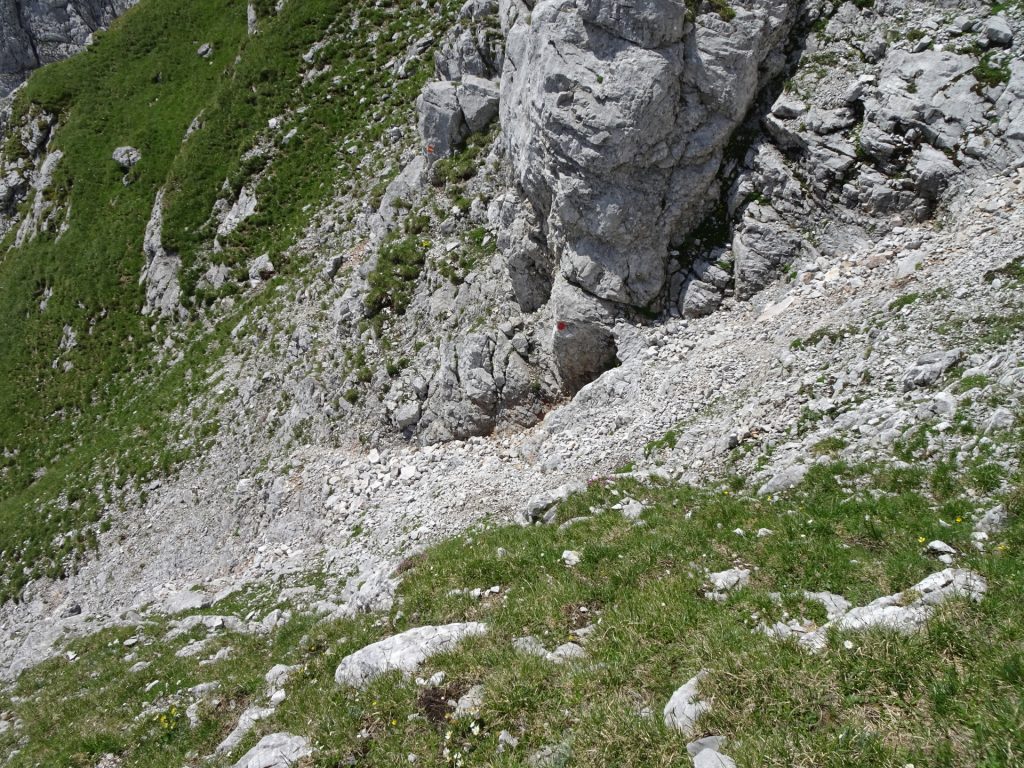 Climb down and cross the scree field (follow the red dots!)