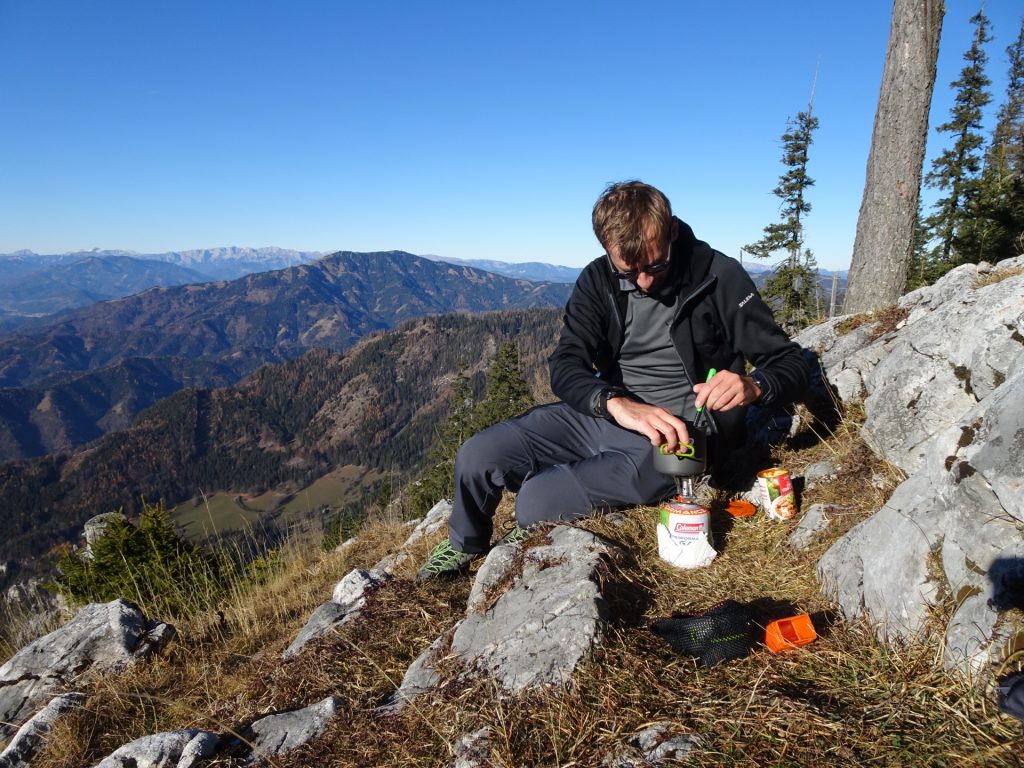 Stefan prepares a warm meal with scenic view