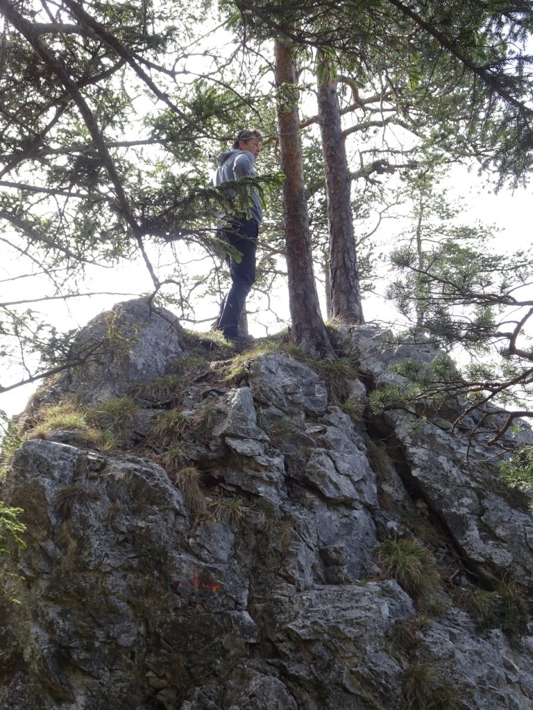 Robert climbs up one of the rocks to gain a better view