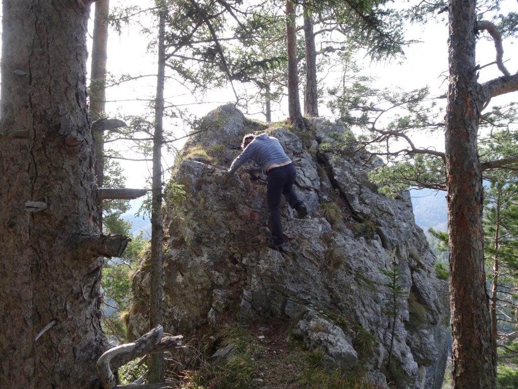 Robert climbs down the rock