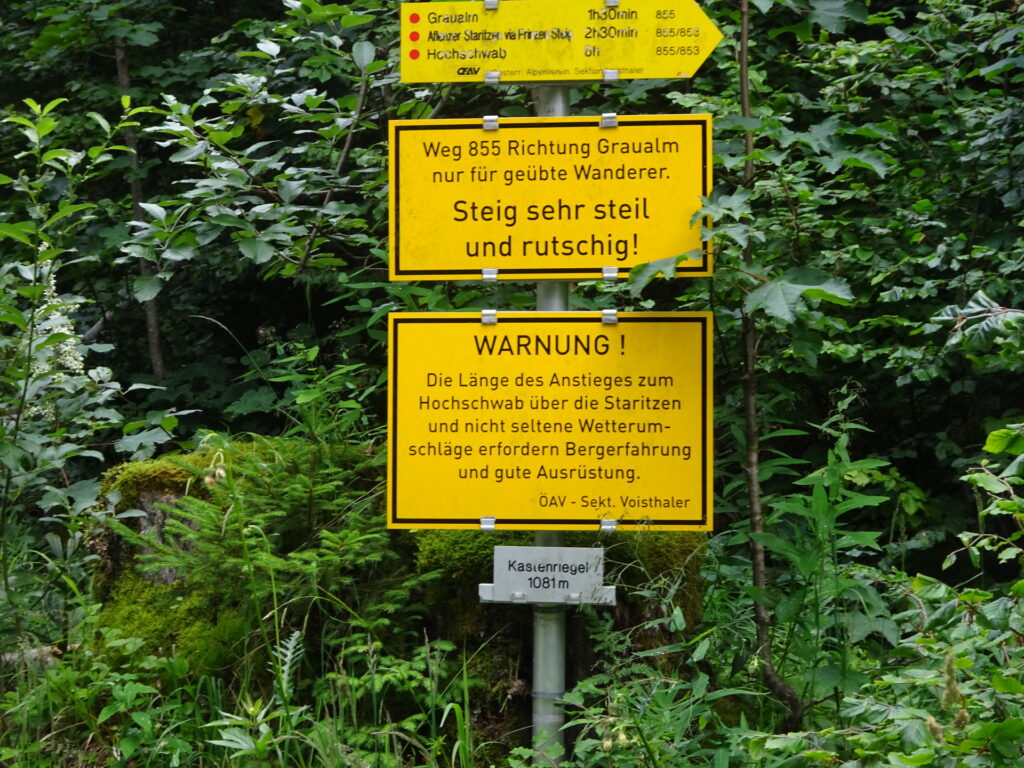 The warning sign is at the end of the trail (after the descent)