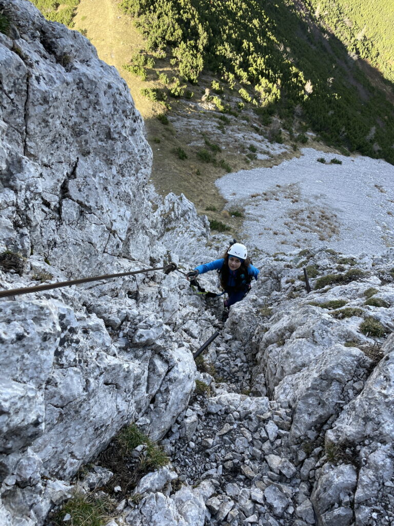 Eliane climbs up the via ferrata