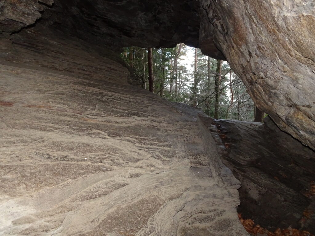 Climbing through the <i>Durchschlupf</i> cave
